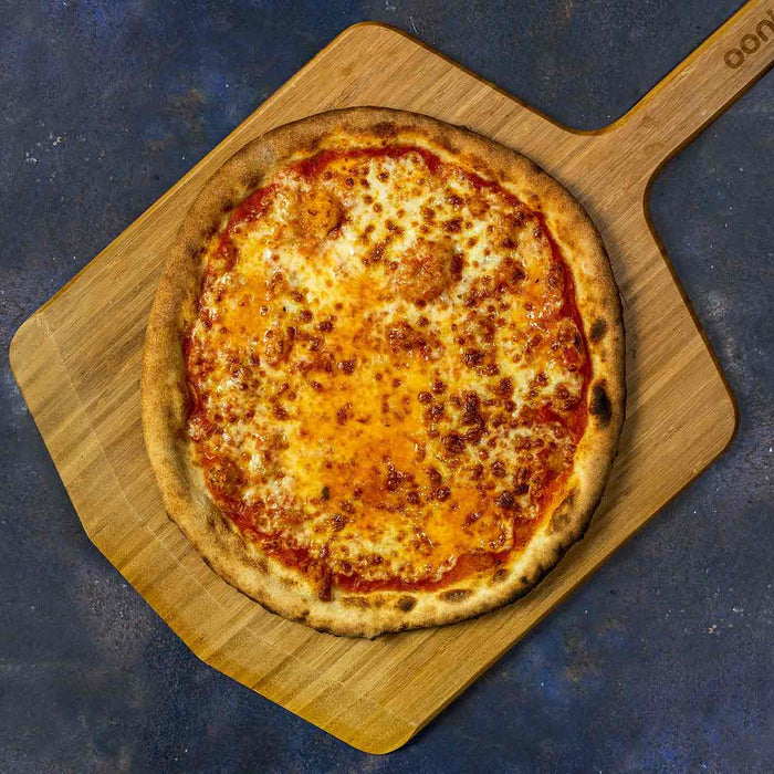 New york style cheese pizza pie on wooden pizza paddle