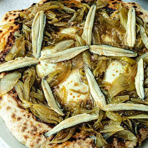 French Pissaladière Pizza with Olive Béchamel, Caramelized Onions, Anchovies and Mozzarella