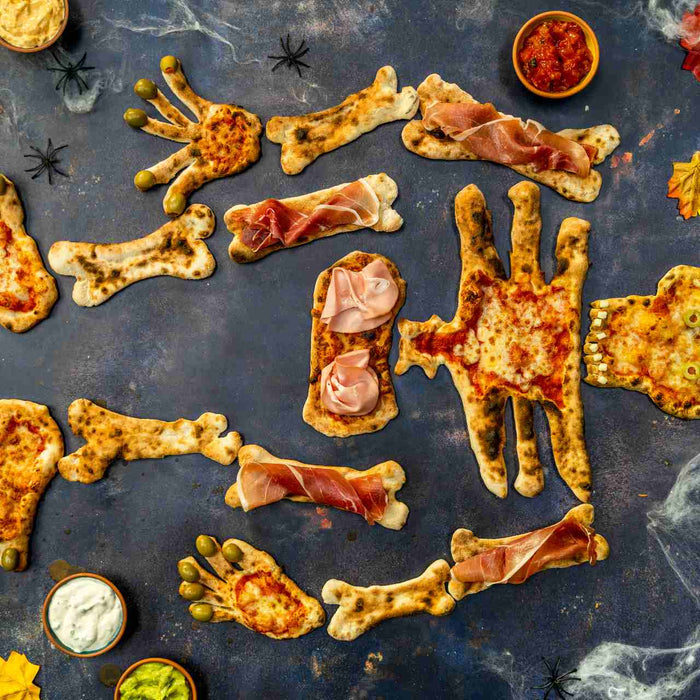 A skeleton pizza with tomato sauce and cheese