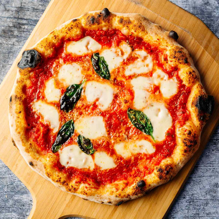 Margherita pizza on a wooden pizza peel