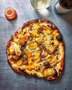 Chanterelle and Sweet Potato Pizza with Sour Tomato Sauce and Pumpkin Seed Butter on a countertop