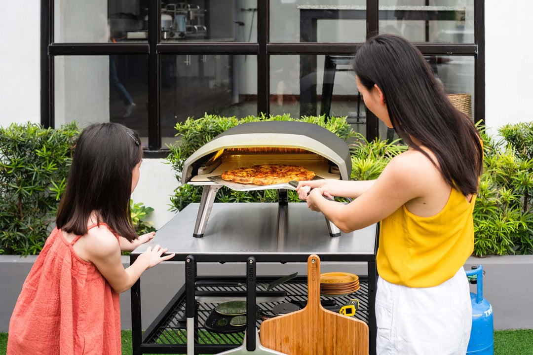 Mother making pizza with daughter