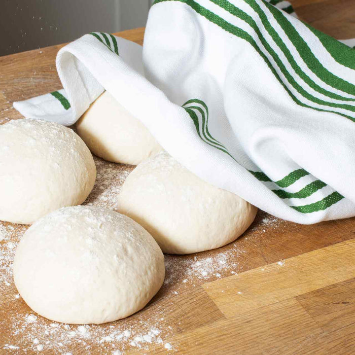 dough balls on a wooden counter top