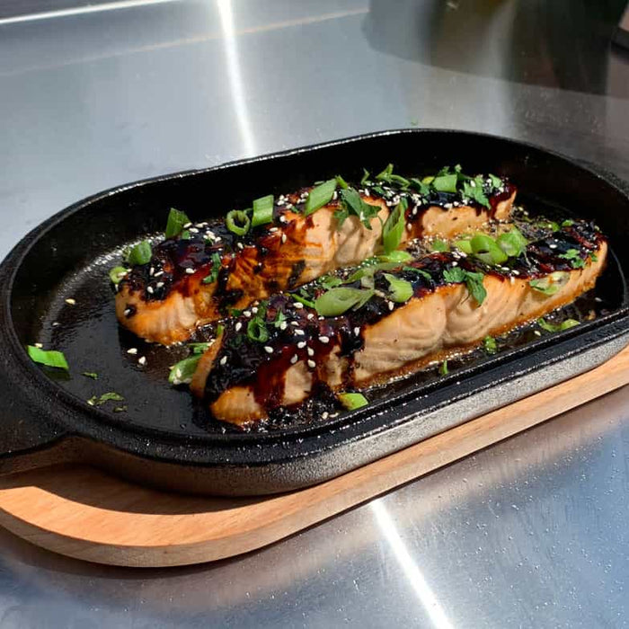 Honey garlic salmon cooked in a cast iron pan using a honey garlic salmon recipe