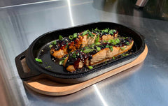 Honey garlic salmon cooked in a cast iron pan using a honey garlic salmon recipe