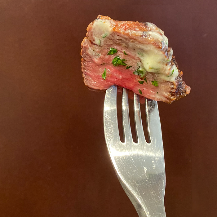 A piece of sous vide steak on a fork. Made in an Ooni using a sous vide steak recipe.