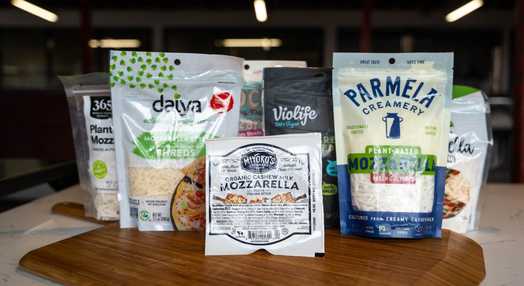 A selection of vegan cheeses on top of a wooden pizza peel