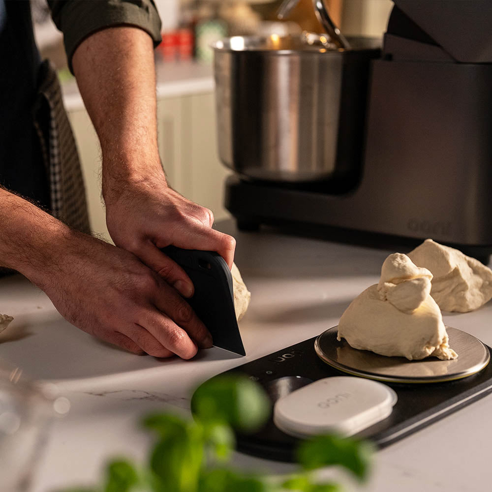 Ooni dough bench scraper dividing dough balls and weighing on ooni digital scales