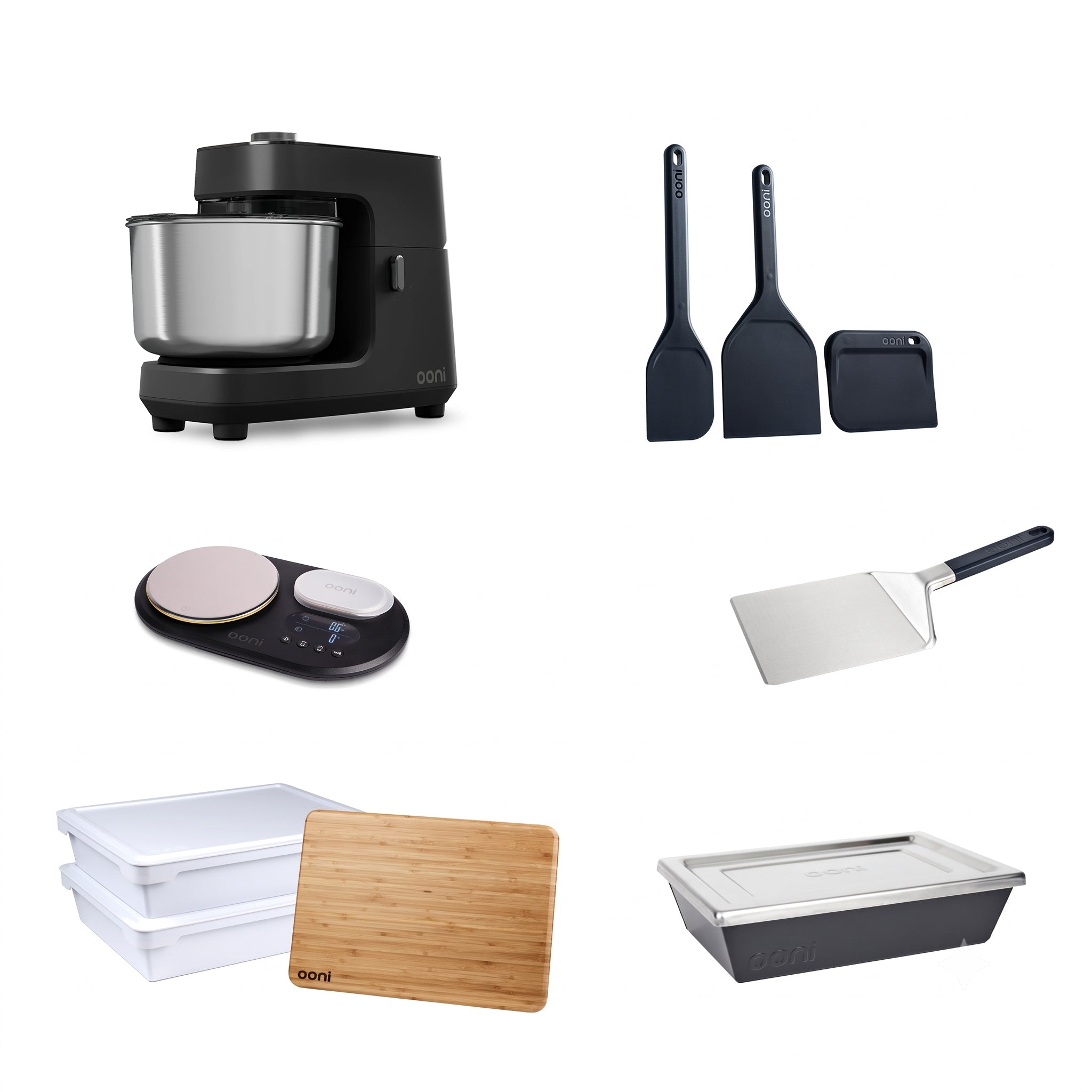 A collection of countertop kitchen appliances and utensils on a white background, including a black stand mixer with a stainless steel bowl, two black spatulas, a black scraper, a digital scale, a metal cake turner, two white storage containers, a bamboo cutting board, and a dark gray rectangular baking pan.  #variant-1