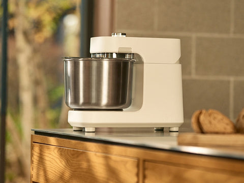 Ooni Halo Pro Spiral Mixer on modern countertop with slices of bread in foreground.
