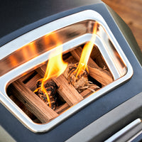 A close-up of oak logs burning in a Karu 12G