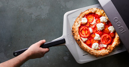 A Perforated Pizza Peel with a Margherita Pizza