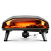 Ooni Koda 2 Max outdoor pizza oven face on baking a pizza and some meat in a griddle pan.