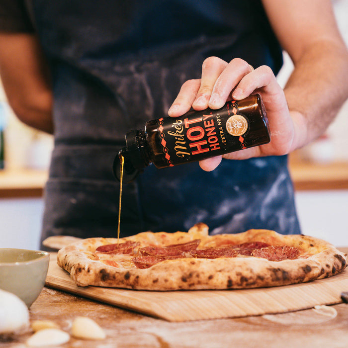 Mike’s Hot Honey Extra Hot drizzled on pizza | Click this image to open up the product gallery modal. The product gallery modal allows the images to be zoomed in on.